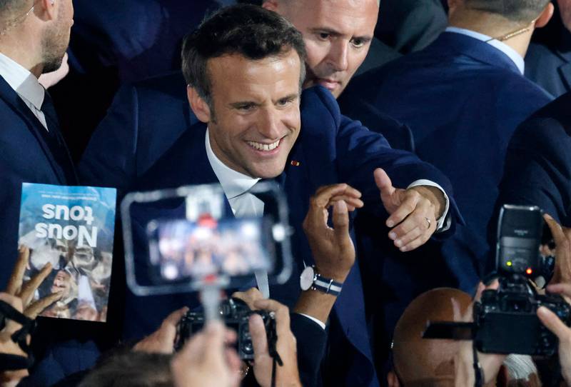 Mr Macron celebrates the victory with his supporters. AFP