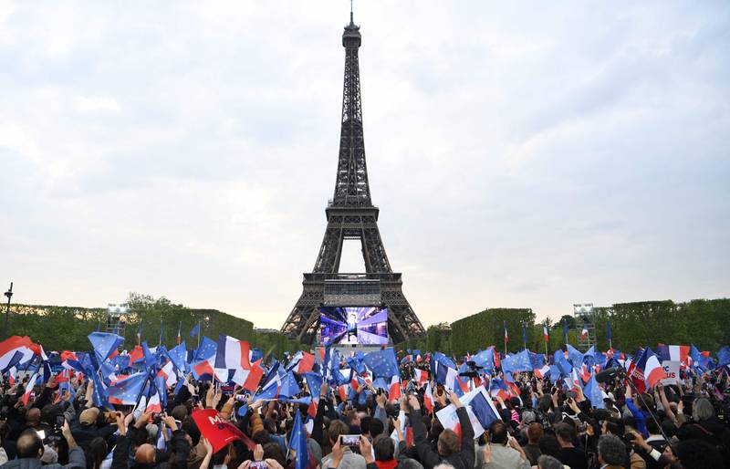 Supporters of Emmanuel Macron celebrate after he won the French presidential election, at the Champ de Mars, in Paris. AFP