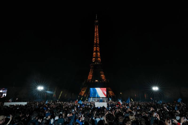 Supporters celebrate with Mr Macron in front of the Eiffel Tower. AP Photo