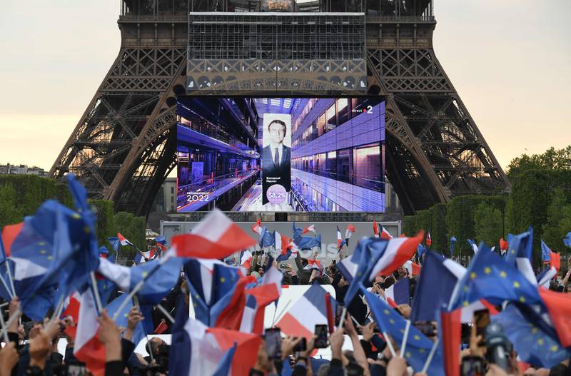 Cheers of joy erupted as Mr Macron's re-election was announced on a giant screen at the foot of the Eiffel Tower. AFP